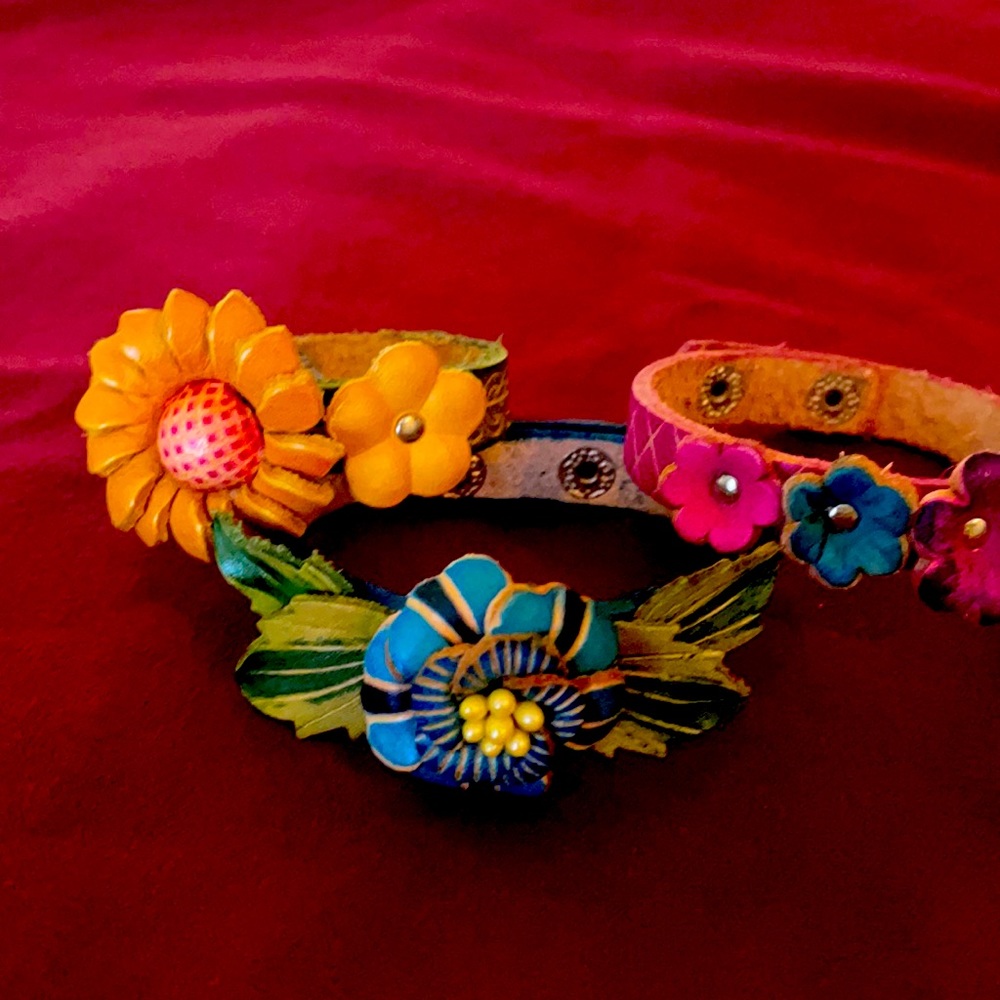 Three leather floral bracelets